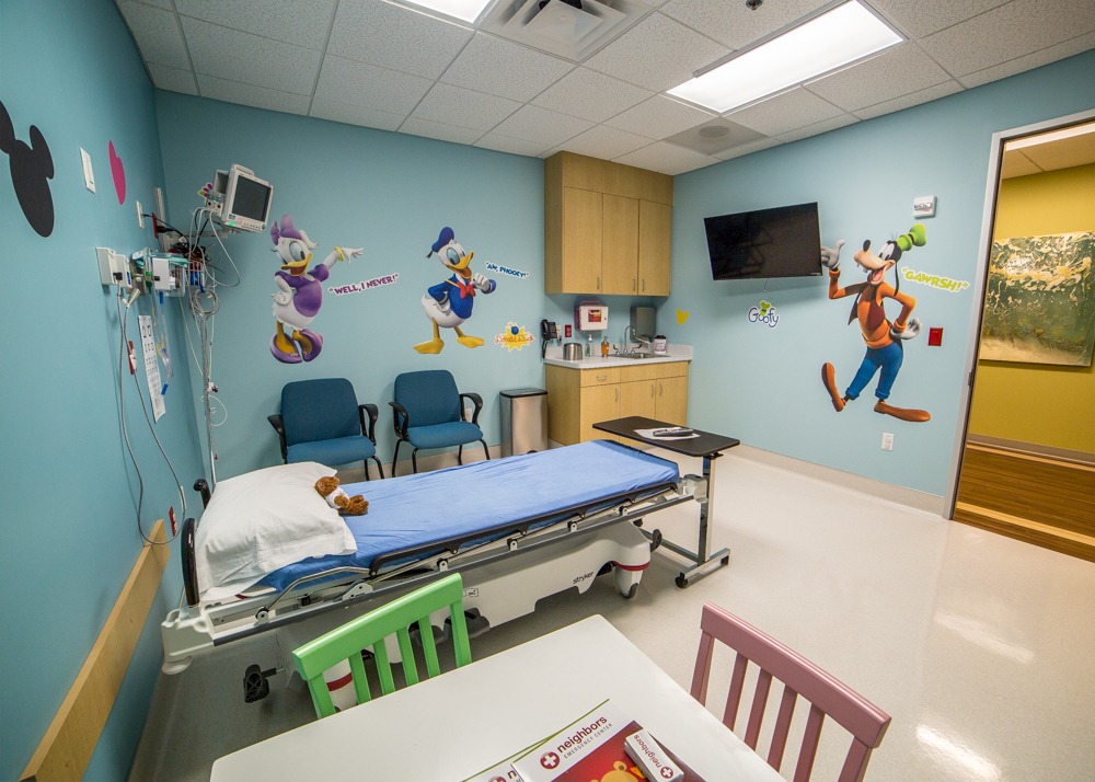 pediatric room with table and cartoons at emergency center