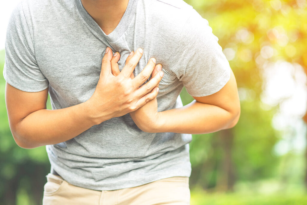 Man grabbing his chest in pain - cardiac arrest