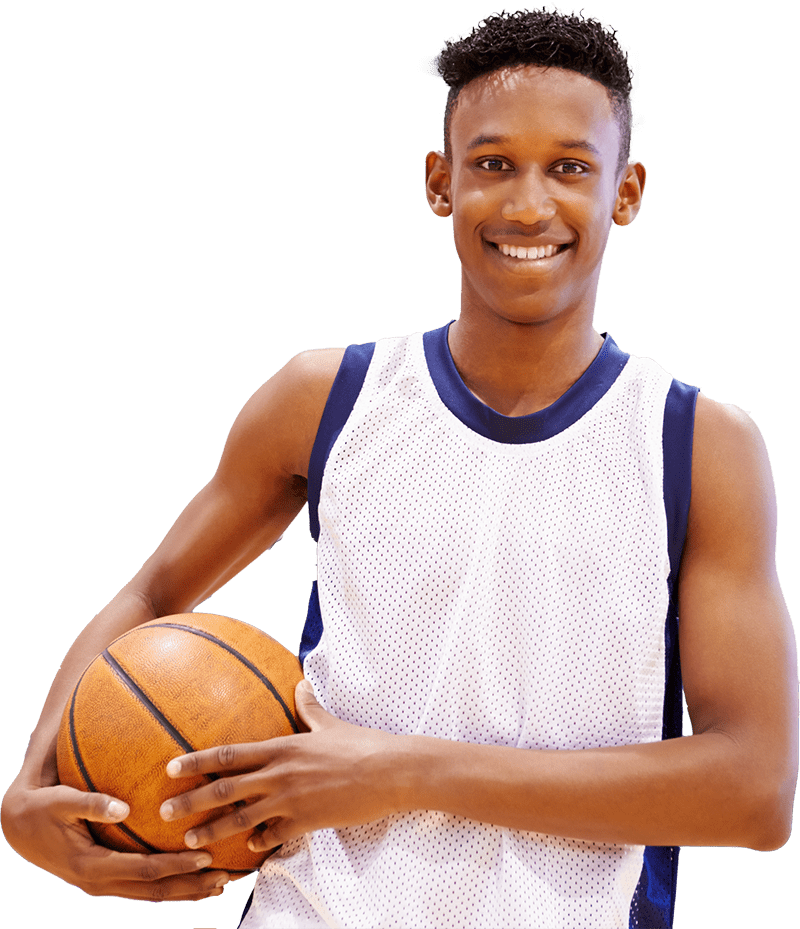 smiling young man holding basketball in his hands