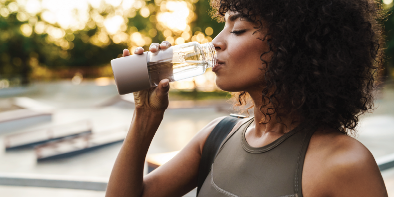 woman drinking water outside