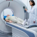 Patient undergoing a CT scan with a technician standing by.