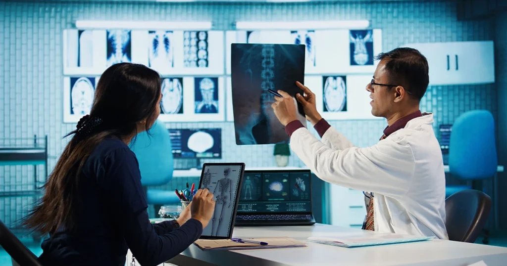 Doctor explains X-ray to patient using tablet.