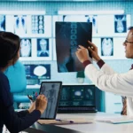 Doctor explains X-ray to patient using tablet.