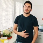 Man suffering from bloating and looking for quick relief.