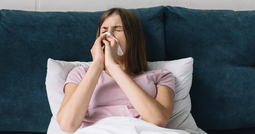 erson lying in bed, struggling to breathe with blocked nose.
