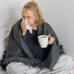 Person experiencing flu symptoms including congestion and fatigue