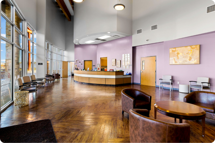 Spacious lobby of Neighbors Emergency Center featuring a reception desk and comfortable seating areas.