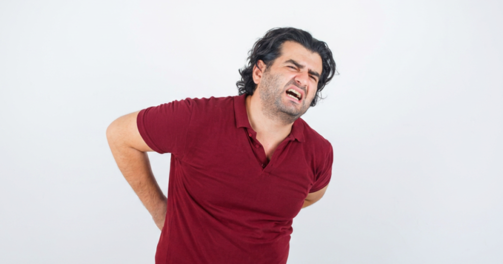 Man holding his middle back in pain.