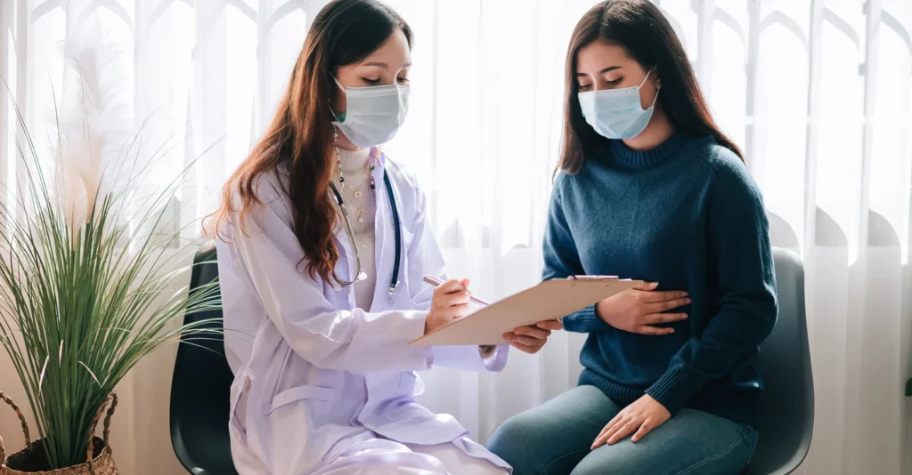 asian-doctor-visit-examines-young-adult-woman