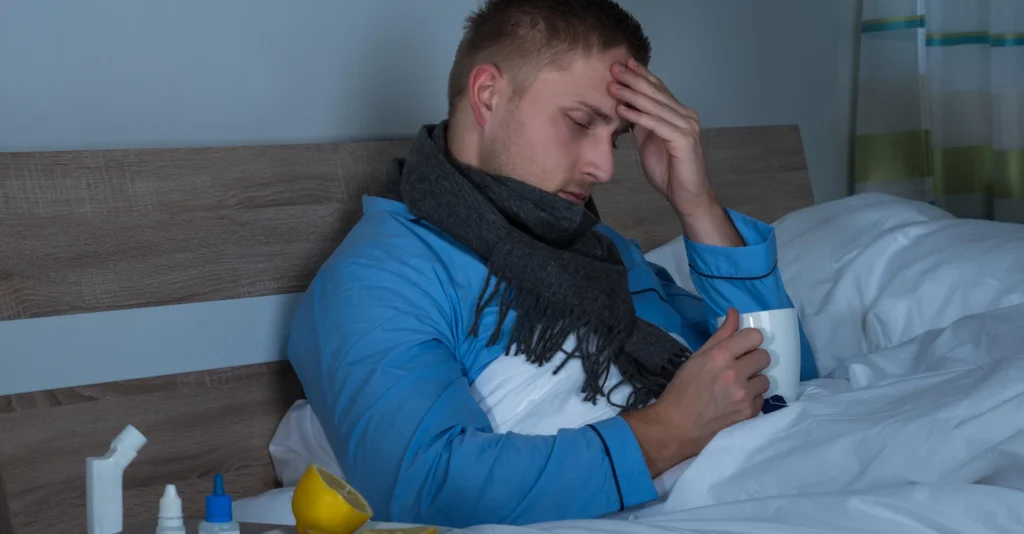 man-suffering-from-headache-sitting-bed