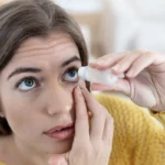 Woman applying eye drops to relieve dry, irritated eyes.