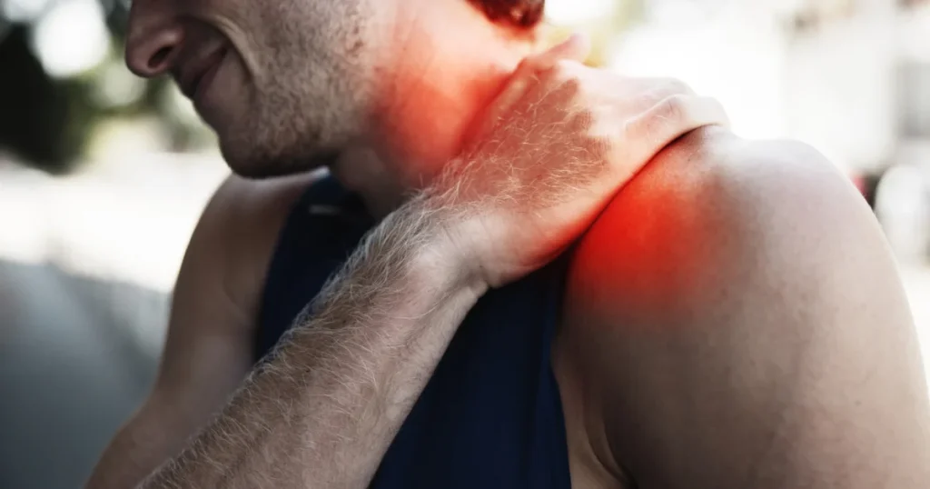Man suffering a shoulder muscle spasm