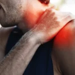 Man suffering a shoulder muscle spasm